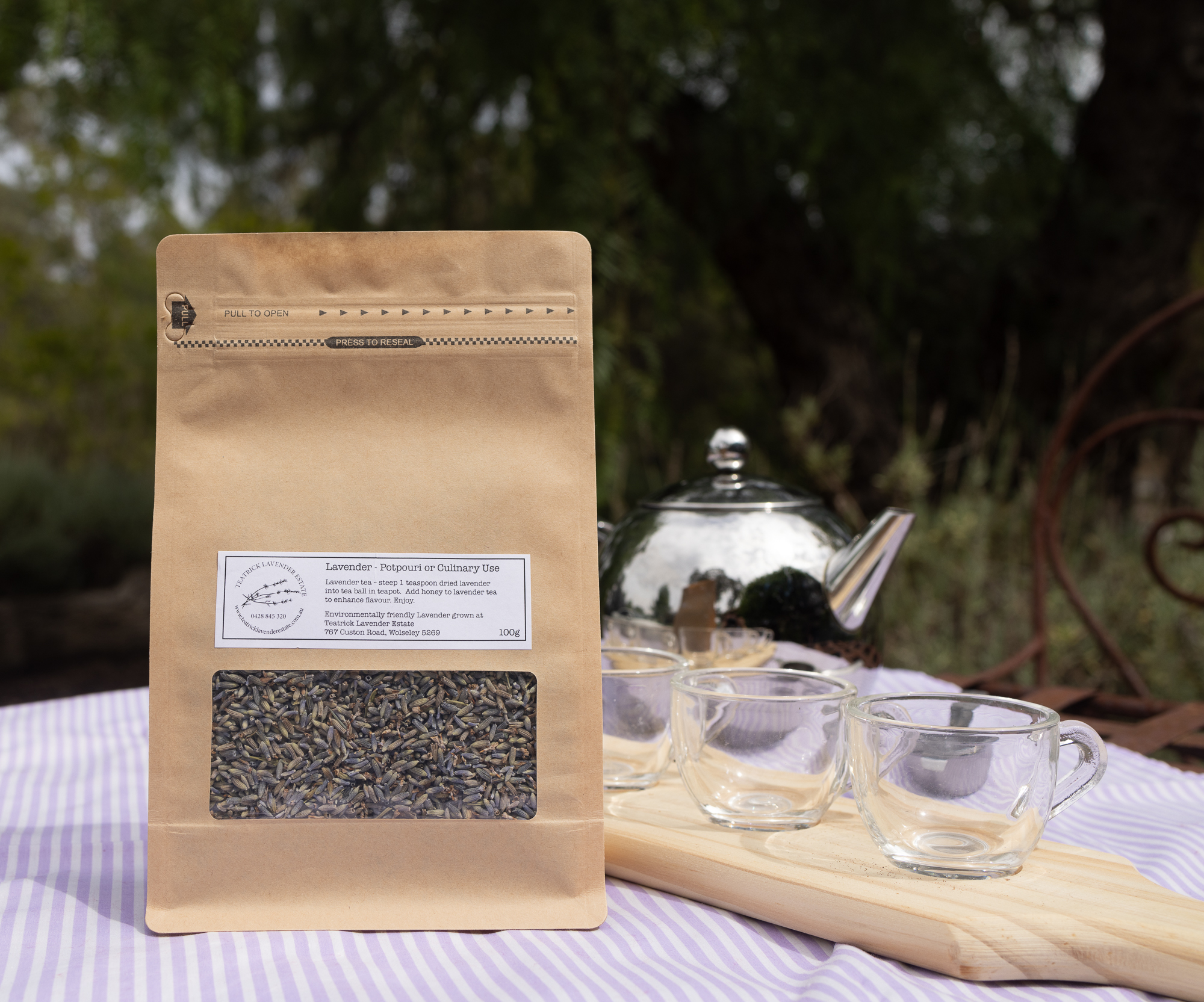 TLE2026-68 eatrick Lavender Estate culinary lavender buds packaged for tea, cooking and baking, displayed with a teapot and teacups.